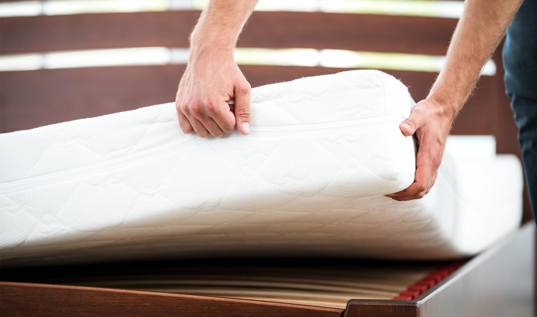 Man lifting mattress